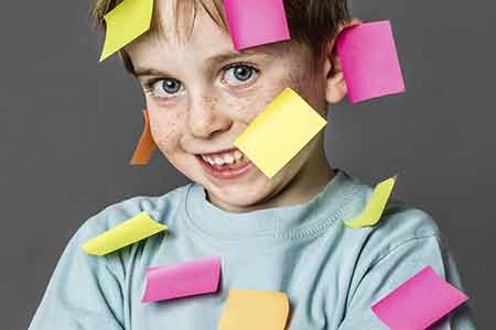 Photo of boy with sticky notes on him